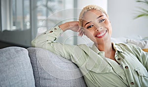 Happy, woman and portrait at home of freelancer relax with a smile on a living room couch. Female person, calm and