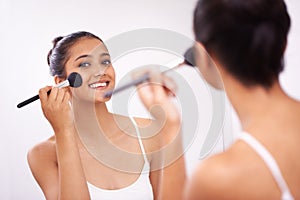 Happy woman, portrait and makeup brush in mirror for beauty, cosmetics or grooming in bathroom at home. Female person