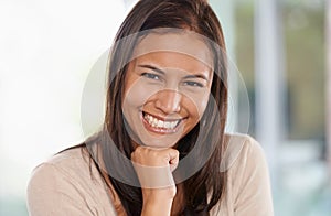 Happy woman, portrait and relax with positive attitude or natural beauty in living room at home. Face of young female