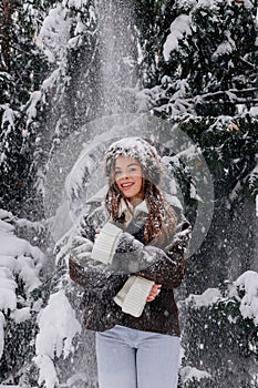 Happy woman portrait at snowy forest, nature woods, ski resort, leisure