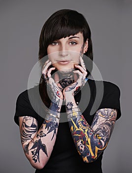 Happy woman, portrait and stylist with tattoo for facial treatment, style or body art on a gray studio background