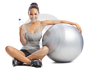 Happy woman, portrait and water by exercise ball for workout or training against a white studio background. Female