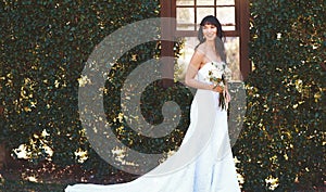 Happy woman, portrait and wedding dress with flowers in nature for marriage, ceremony or commitment. Married, young