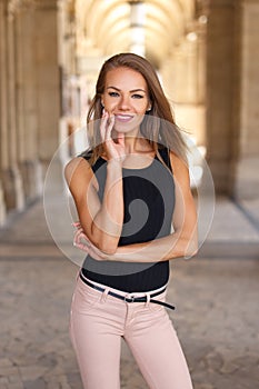 Happy woman posing in city with toothy smile