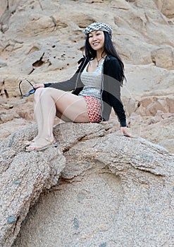 Happy woman posing on rocks