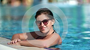 Happy woman posing at swimming pool enjoying summer vacation. Medium close up shot on 4k RED camera