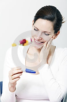 Happy woman with positive pregnancy test