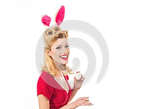 Happy woman preparing for Easter. Beautiful blonde girl with bunny ears and Easter egg. Pretty girl hunts for Easter