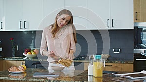 Happy woman preparing healthy breakfast. Relaxed person speaking on mobile phone
