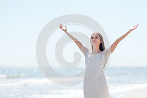 Happy Woman with Raised Arms By the Sea