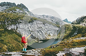 Happy woman raised hands with backpack hiking