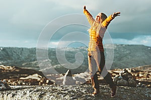 Happy Woman raised hands enjoying landscape