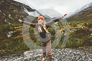 Happy woman raised hands walking in forest mountains