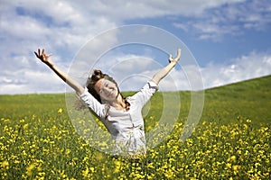 Happy woman in rapeseed field