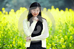 Happy woman in rapeseed field