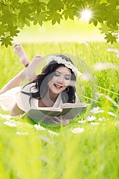 Happy woman read book outdoor