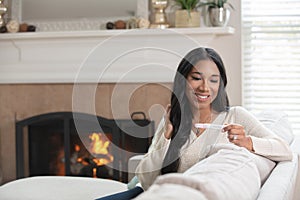 A happy woman reads her pregnancy test