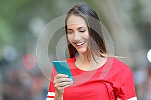 Happy woman reads a message on a smart phone