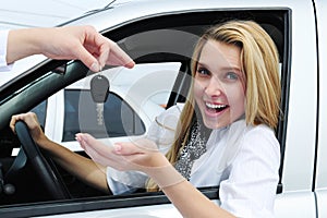 Happy woman receiving car key