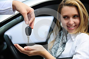 Happy woman receiving car key