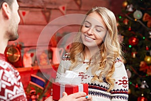 Happy woman receiving gift box from her boyfriend