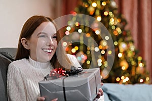Happy woman receiving a present at Christmas photo