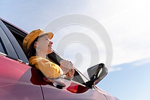 Happy woman in a red car