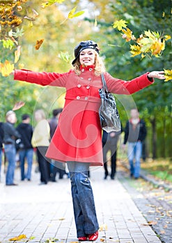 Happy woman in red throwing