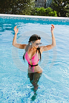 Happy woman relax in swimming pool on summer vacations