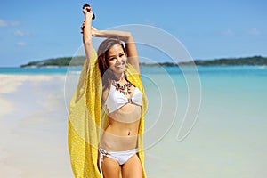 Happy woman relaxing at the beach. Summer vacations concept