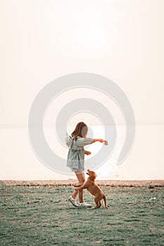 Happy woman relaxing with a dog in the holiday morning, traveling and slow life, resting style, camping.