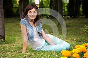 Happy woman relaxing in the park. Beautiful young woman outdoors. Enjoy nature. Healthy smiling girl on spring meadow. Beautiful