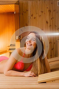 Happy woman relaxing in sauna. Spa wellbeing.