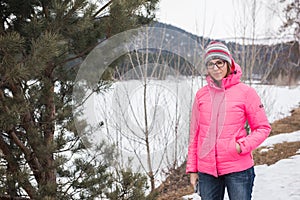 Happy woman relaxing on the top of mountain