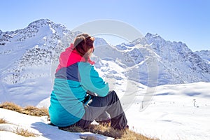 Happy woman relaxing on the top of mountain under blue sky with sunlight at sunny winter day, travel vacation, landscape mountains