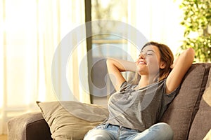 Happy woman resting comfortably at home photo