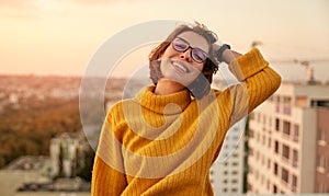 Happy woman resting on roof