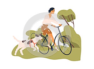 Happy woman riding bicycle with dog tied to bike. Pet owner cycling with doggy running nearby. Cyclist walking with