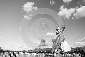 Happy woman at river bridge on eiffel tower in paris, france. Travelling on summer vacation. Girl with fashion look and