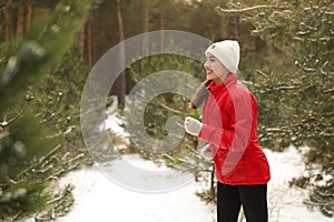 Happy woman running in winter forest.