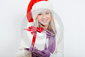 Happy woman in santa hat holding gift box