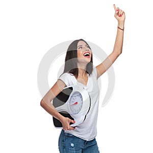 Happy woman with scale celebrating and pointing finger