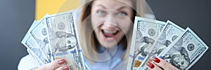 Happy woman screaming and holding lot of money in her hands clos