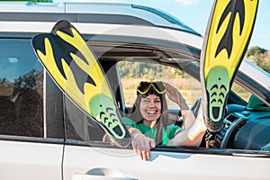 happy woman in scuba mask stick out legs in flippers car travel sea vacation