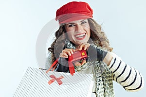 Happy woman shopper showing credit card in heart shaped hands