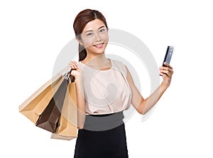 Happy woman with shopping bag and mobile phone
