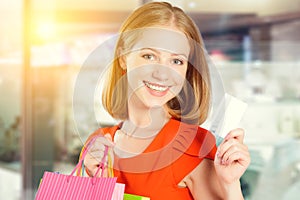 Happy woman on shopping with bags and credit cards, christmas sa