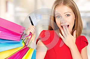 Happy woman on shopping with bags and credit cards, christmas sales, discounts