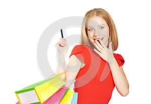 Happy woman on shopping with bags and credit cards isolated on white