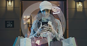 Happy woman shopping and connecting with her phone